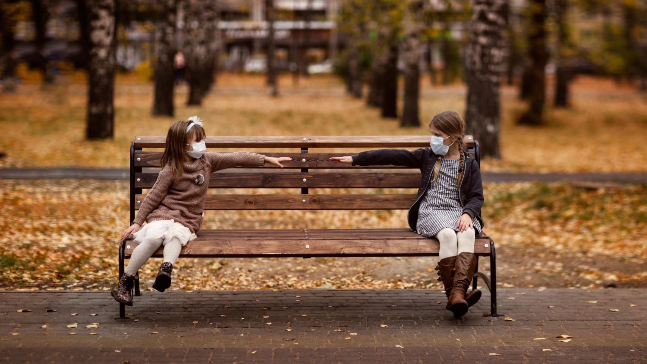 children-two-girls-friends-for-a-walk-in-the-park-children-sit-on-a-bench-wearing-masks-social_t20_gLvOek.jpg