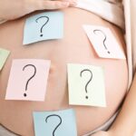 Pregnant belly with Question Post-Its