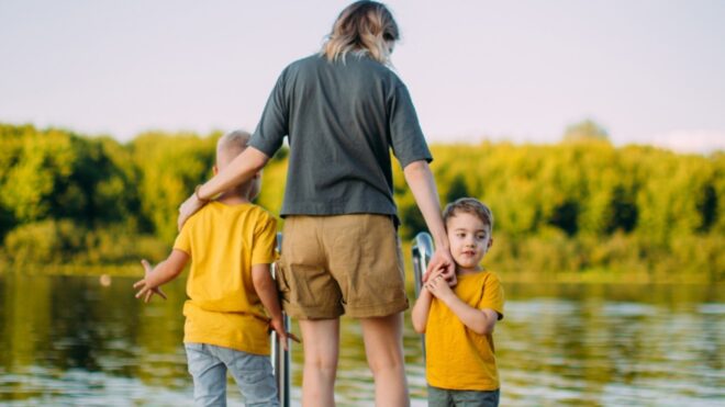 cool-baby-boys-with-mother-holding-hands-stand-on-pier-summer-for-picture-id1267658700 (1)