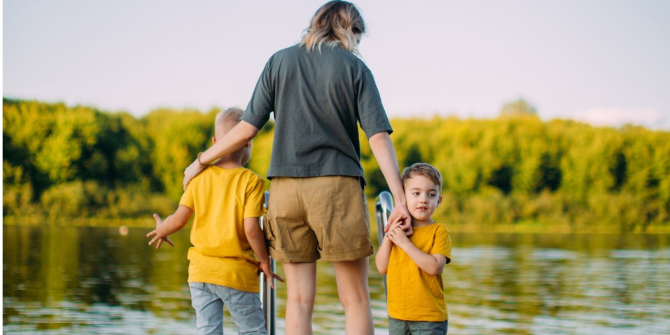 cool-baby-boys-with-mother-holding-hands-stand-on-pier-summer-for-picture-id1267658700 (1)