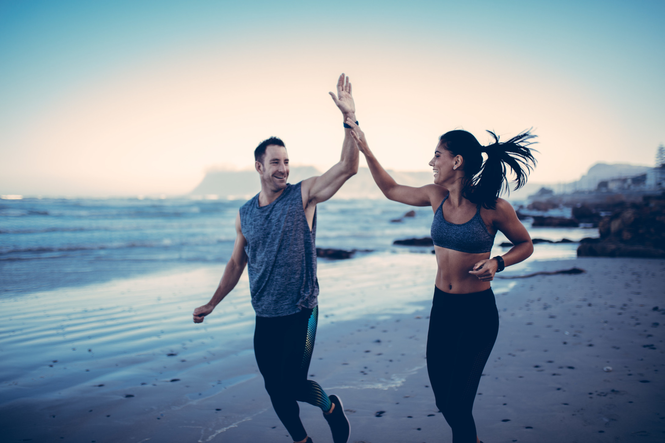 couple-giving-each-other-high-five-after-good-run-at-the-beach_t20_XQgLWV.jpg