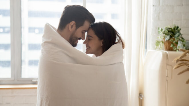 couple in blanket in kitchen