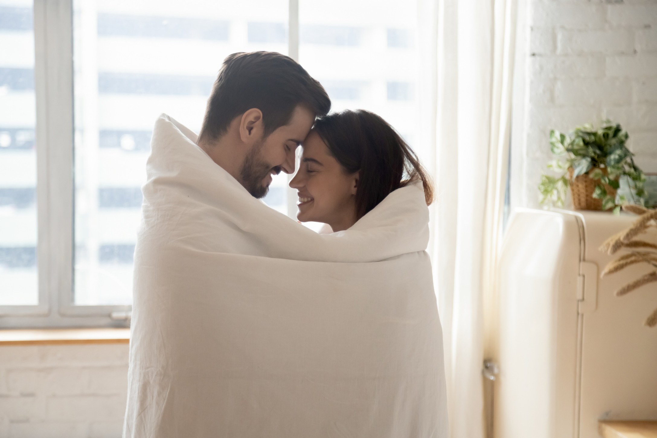 couple in blanket in kitchen