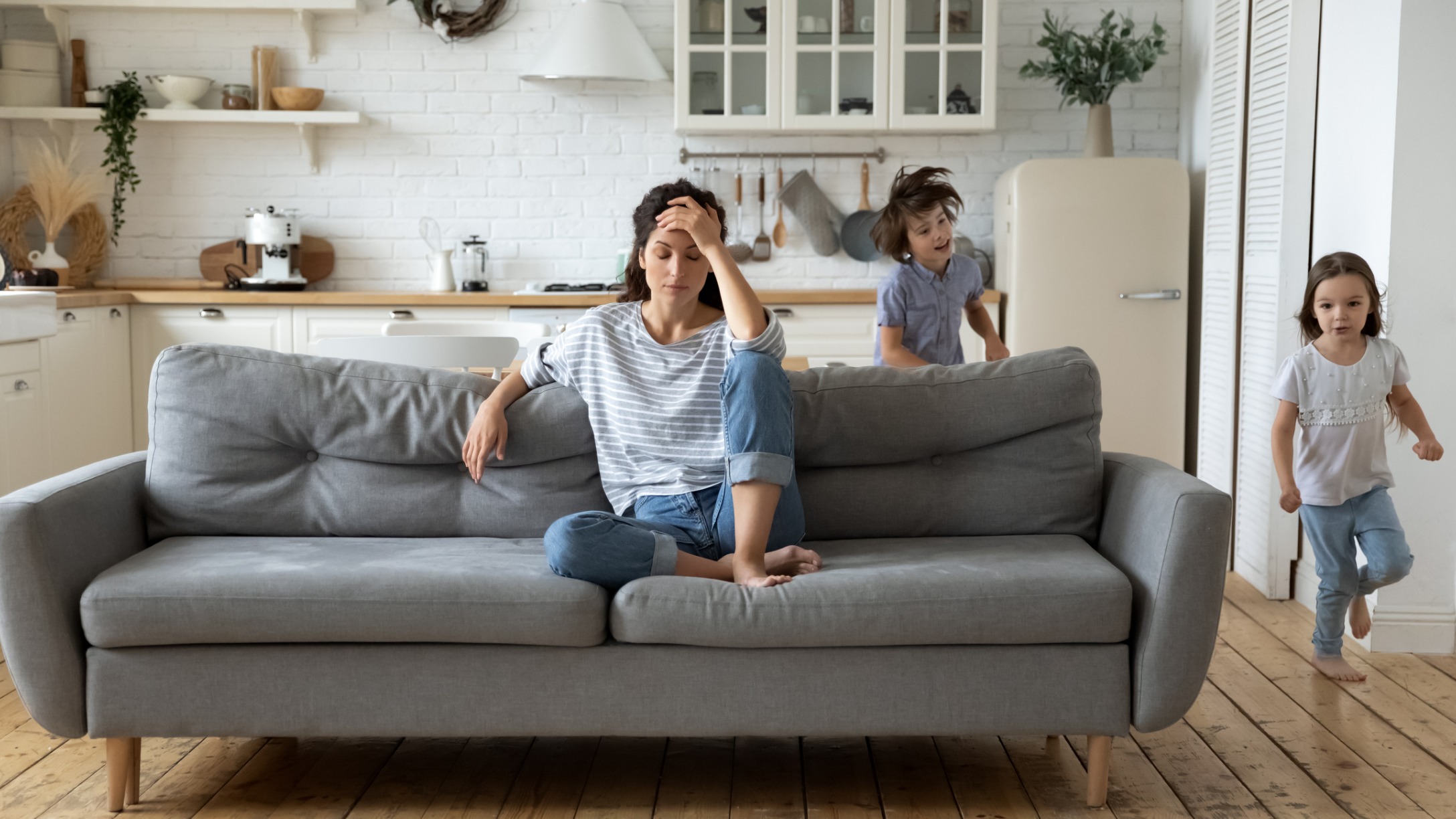 Exhausted Mom with Kids Running Around