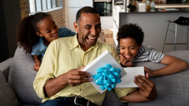 father receiving gift from two kids