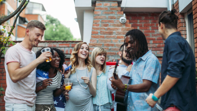 men and women at baby shower party