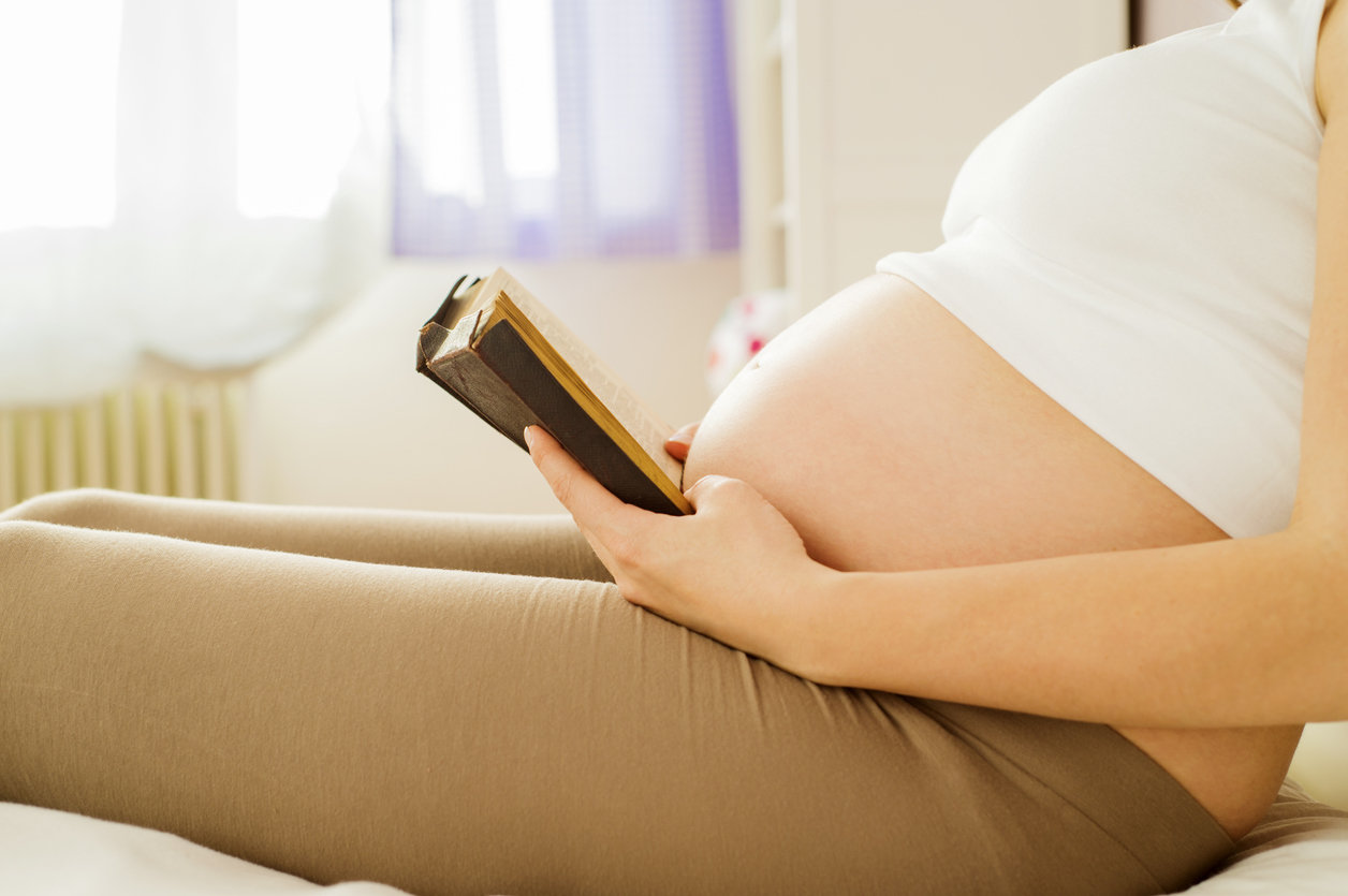 pregnant woman reading bible