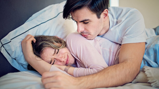 woman crying in bed