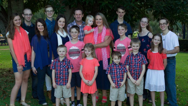 The entire Bonell family poses for a group photo outside.