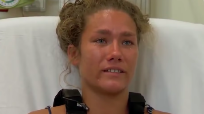Hanna Pignato has tears in her eyes while speaking to reporters from her hospital bed.