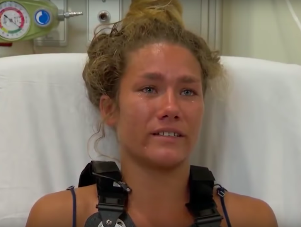 Hanna Pignato has tears in her eyes while speaking to reporters from her hospital bed.