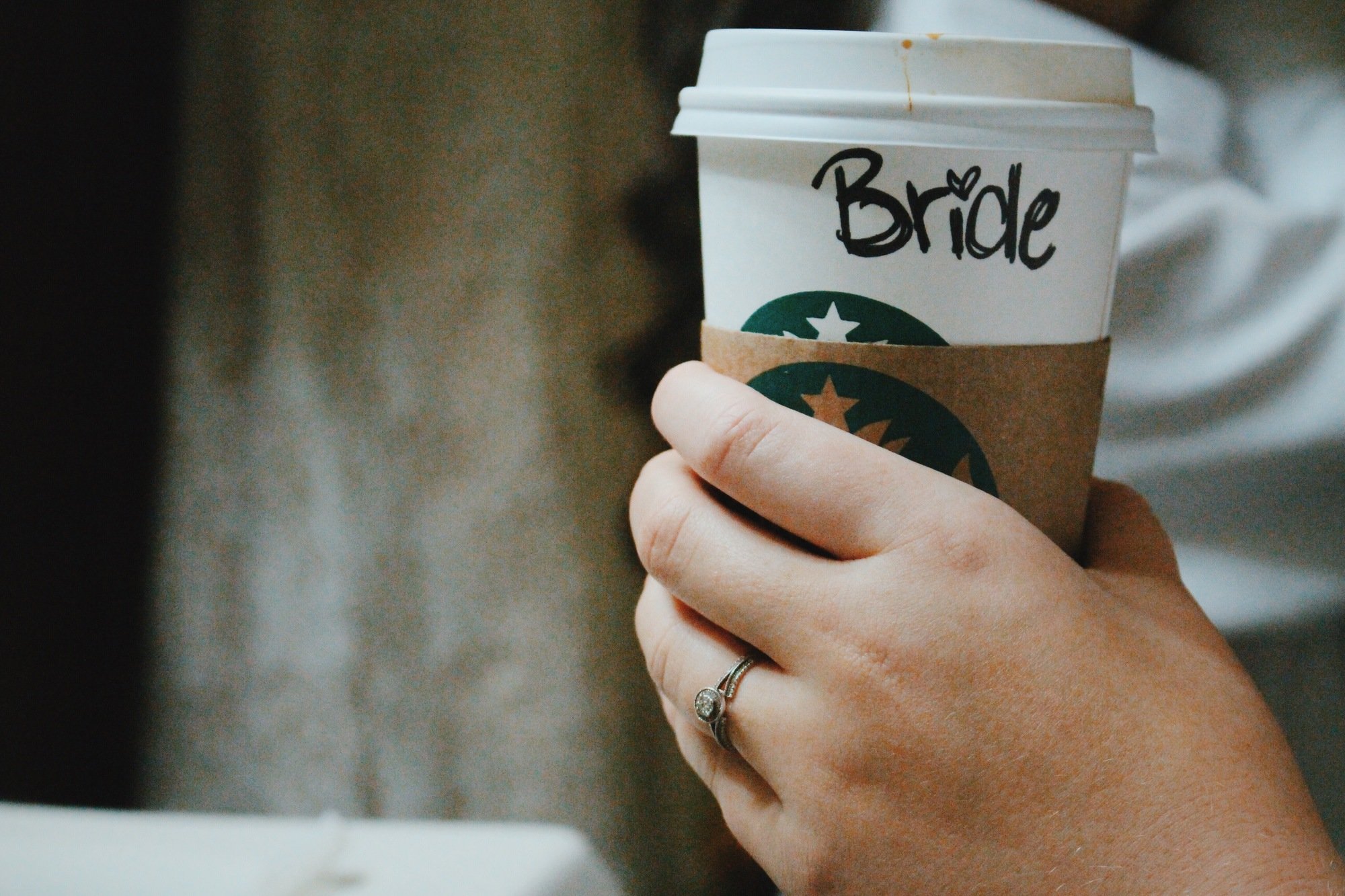 Bride holding starbucks cup