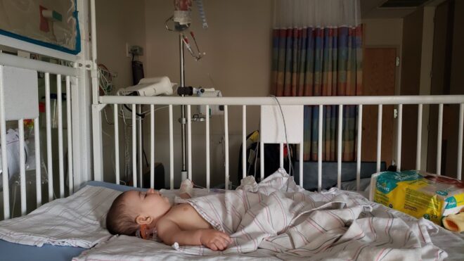Baby in hospital bed