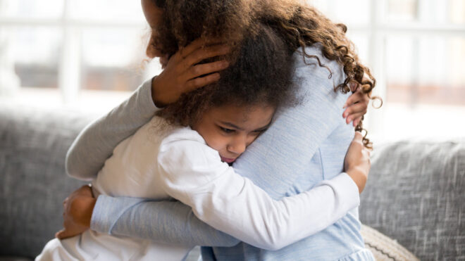Mother comforts child who is upset.