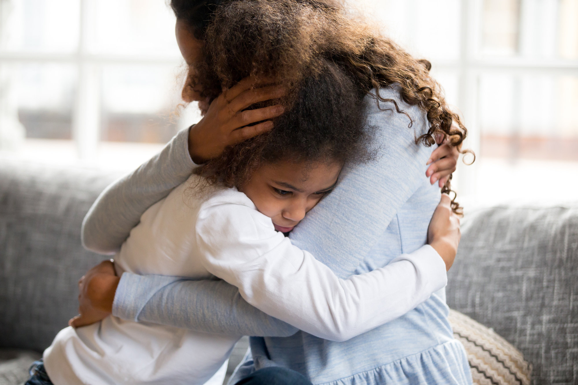 Mother comforts child who is upset.