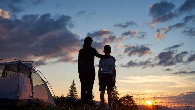 Mom with her son outside camping