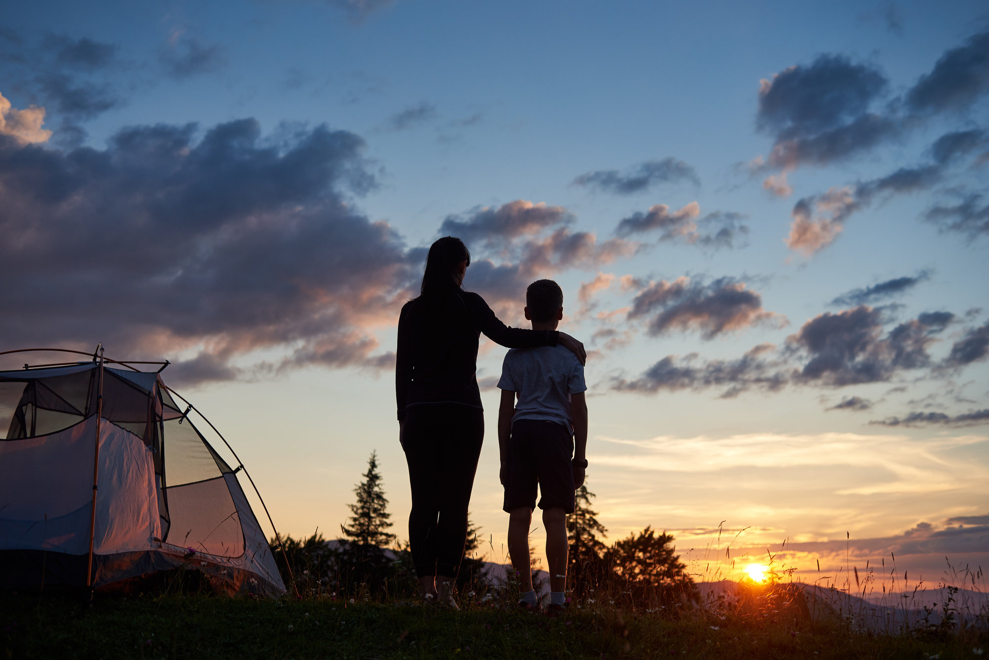 Mom with her son outside camping