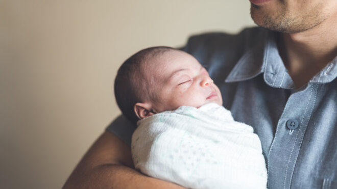 Dad holding newborn