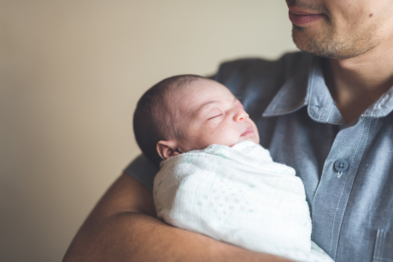Dad holding newborn