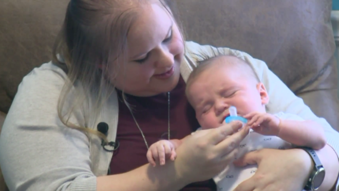 Emily Manley cuddles her newborn baby Jettson.