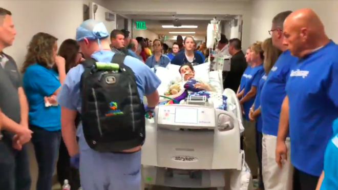 Mason Bogard is wheeled down a hospital corridor for his