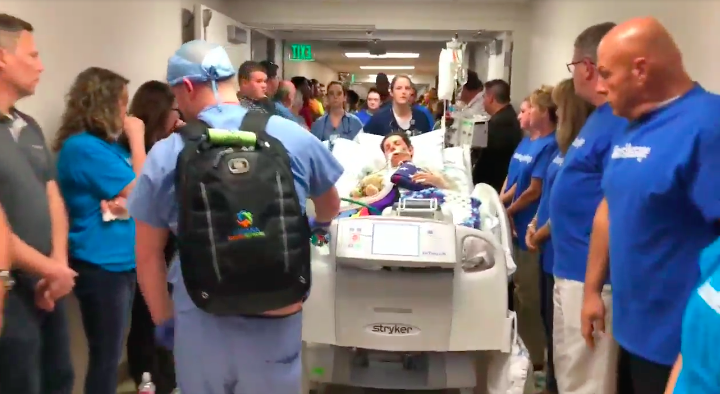 Mason Bogard is wheeled down a hospital corridor for his