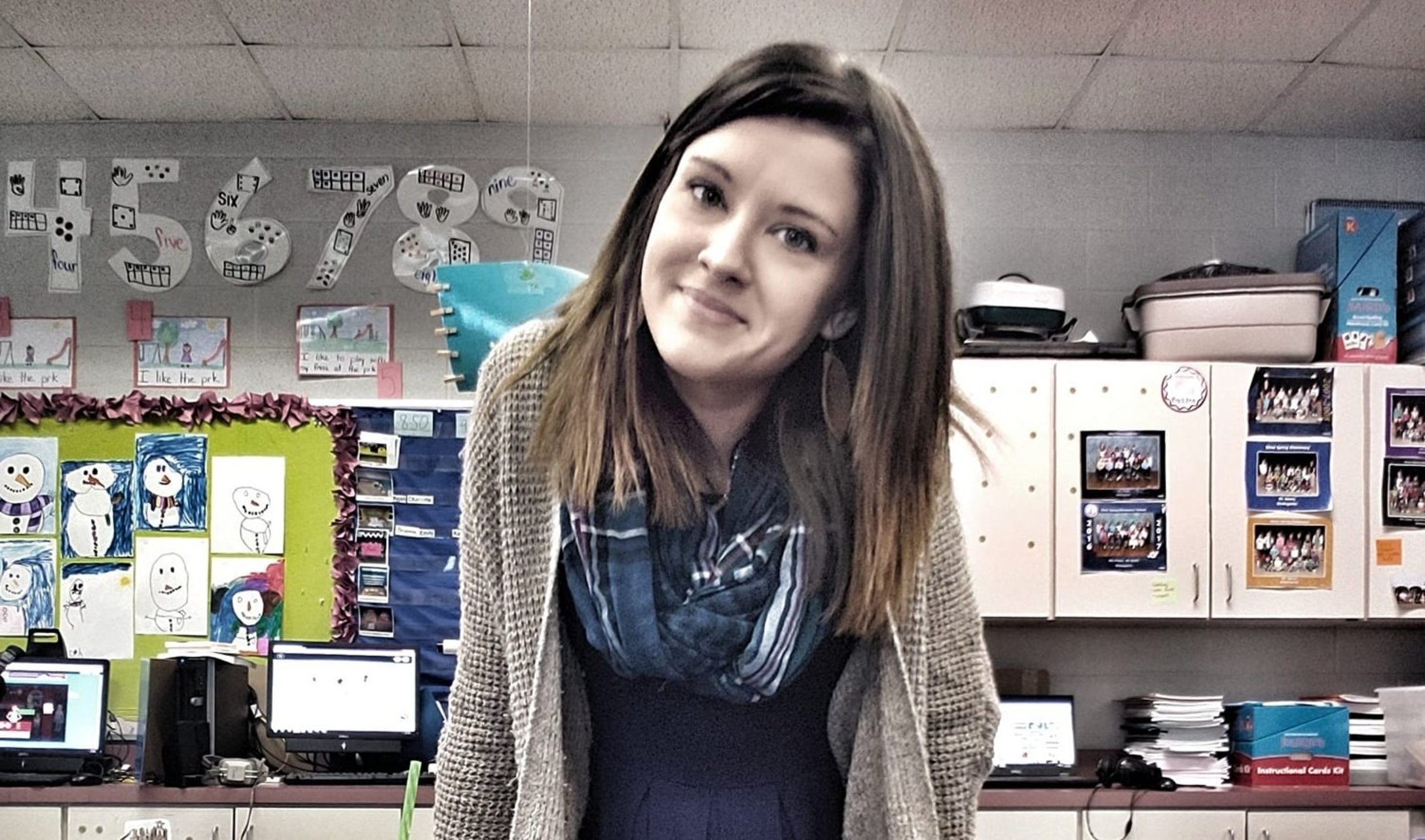 Jessica Gentry sits on a desk in her classroom