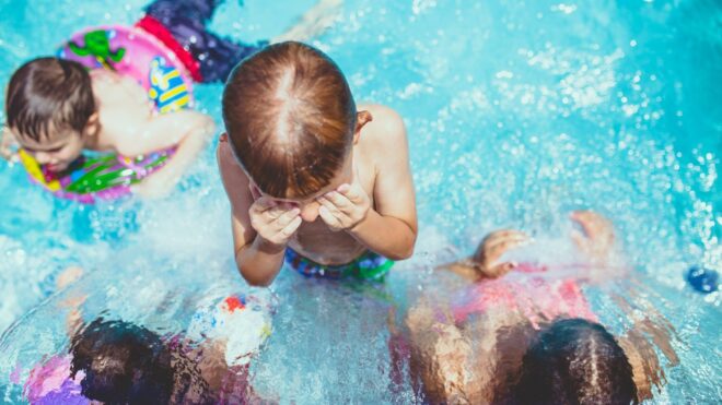 Kids swim in a public pool