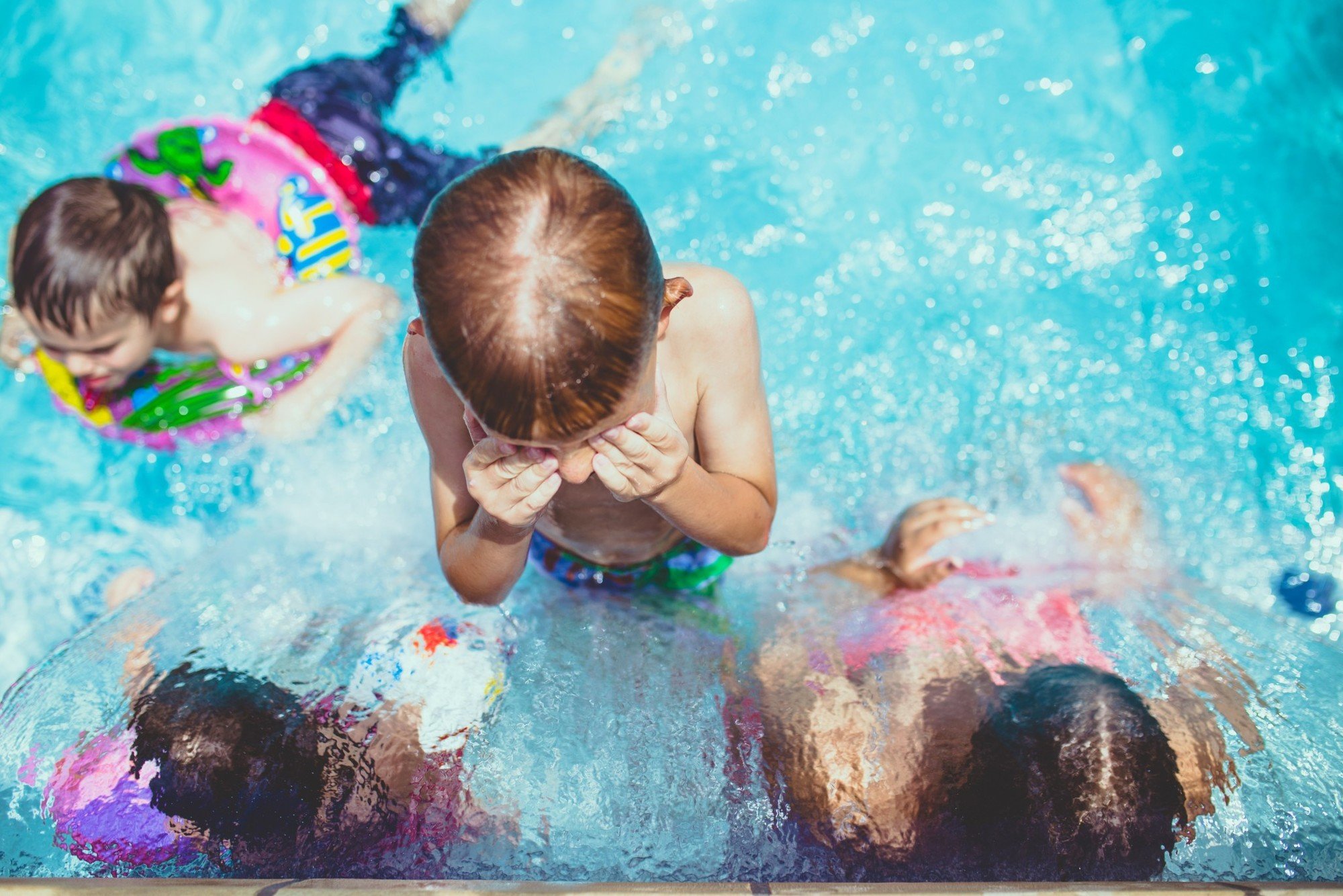 Kids swim in a public pool