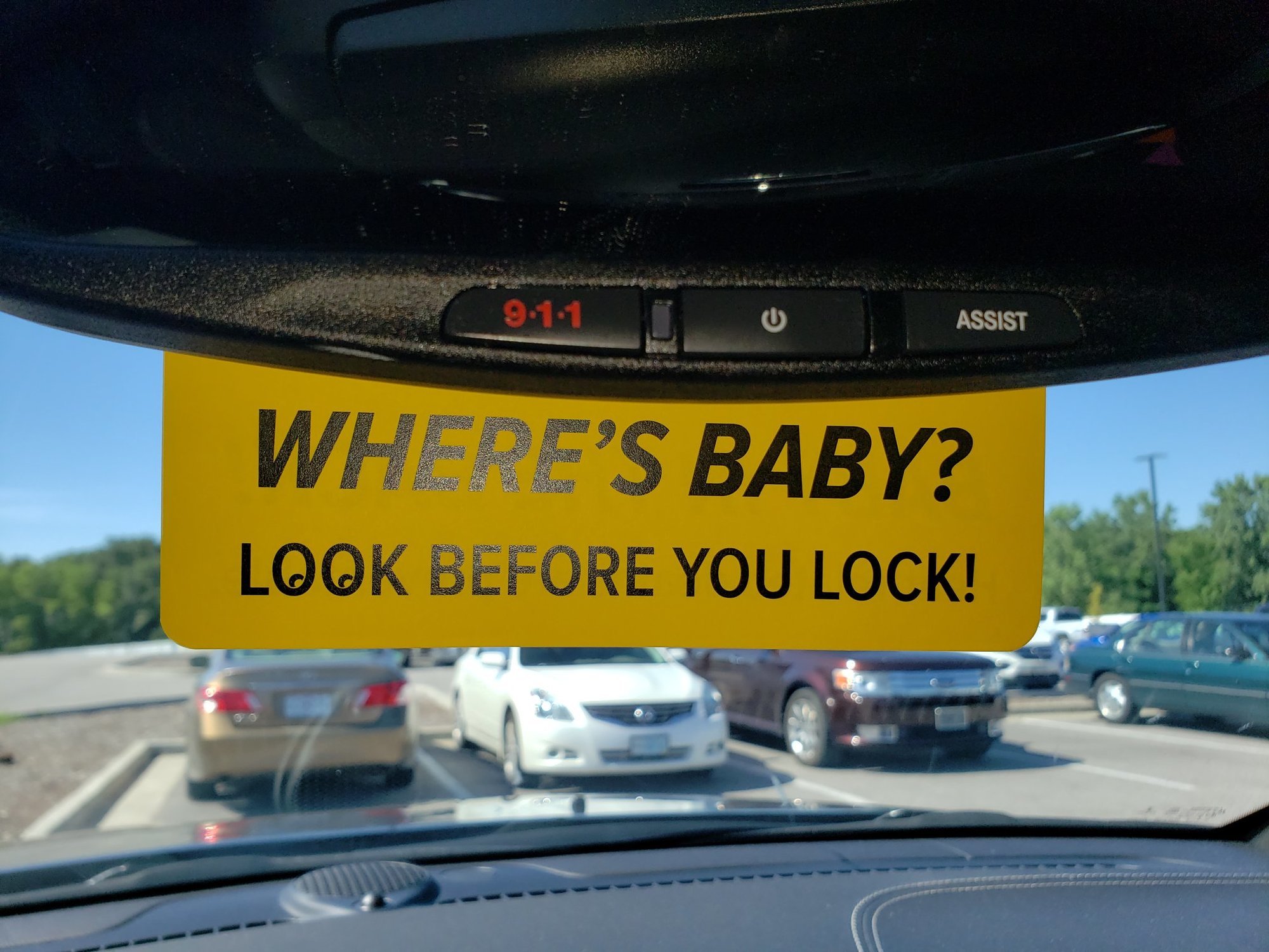 Yellow rearview mirror tag reads