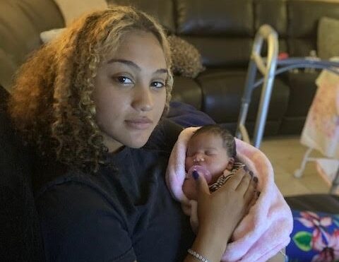 Selena Gray holds her daughter