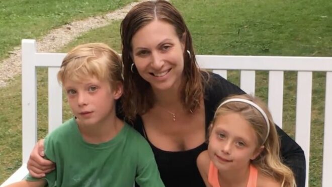 Lara Bazelon smiles while posing with her two kids
