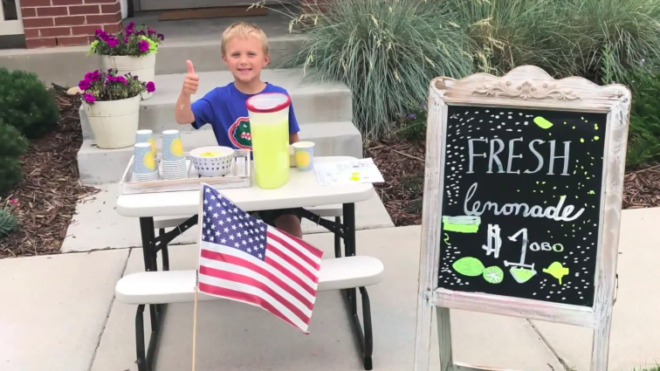 Brady in front of his lemonade stand