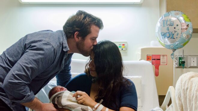 Man with new mom in delivery room