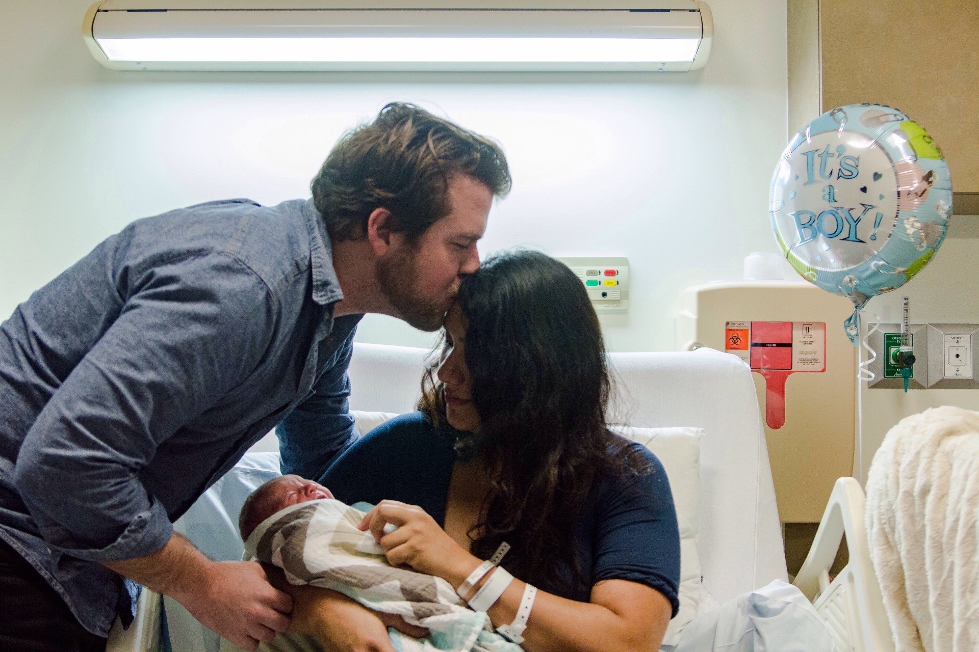 Man with new mom in delivery room