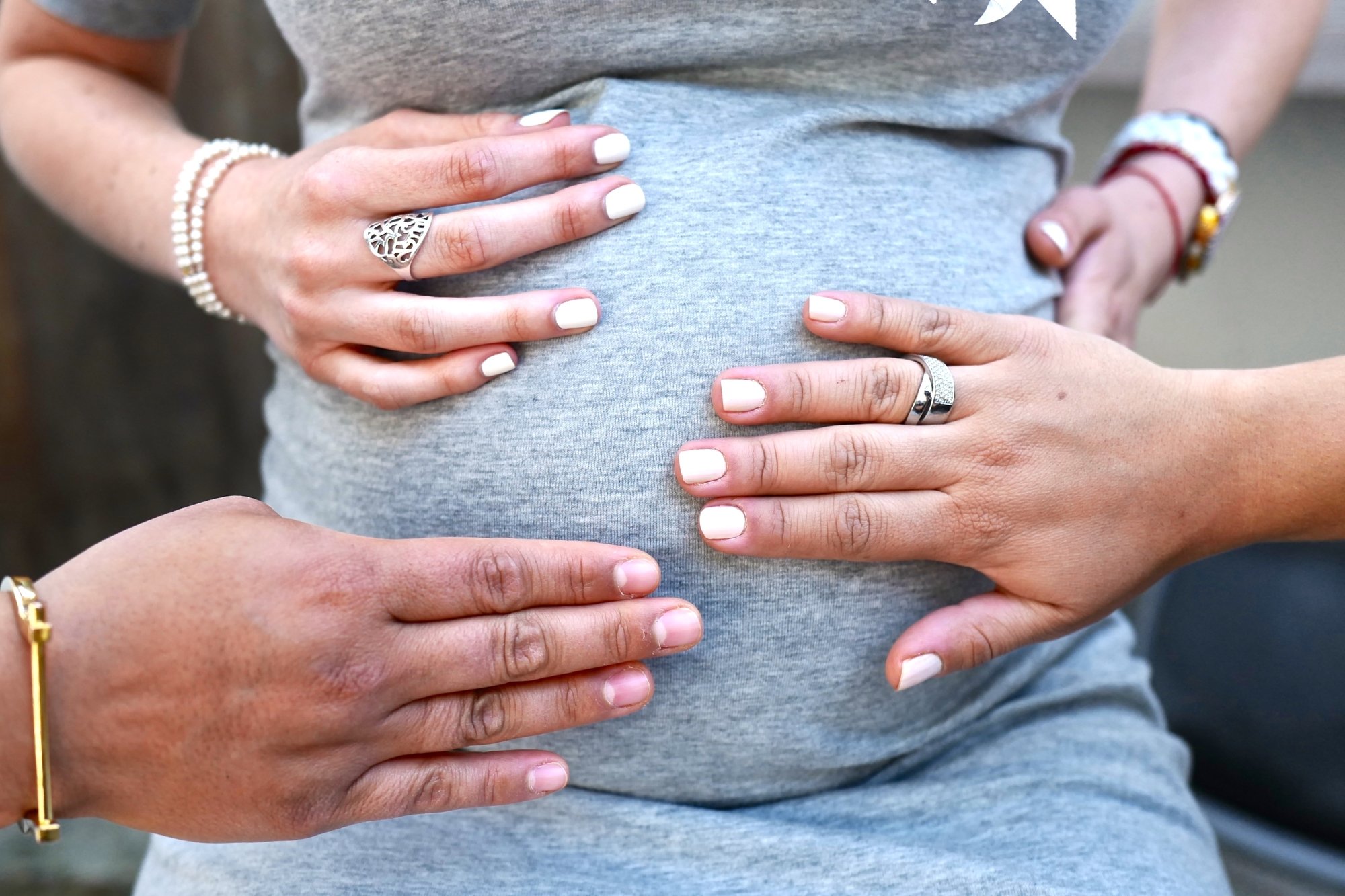 Hands touching pregnant belly