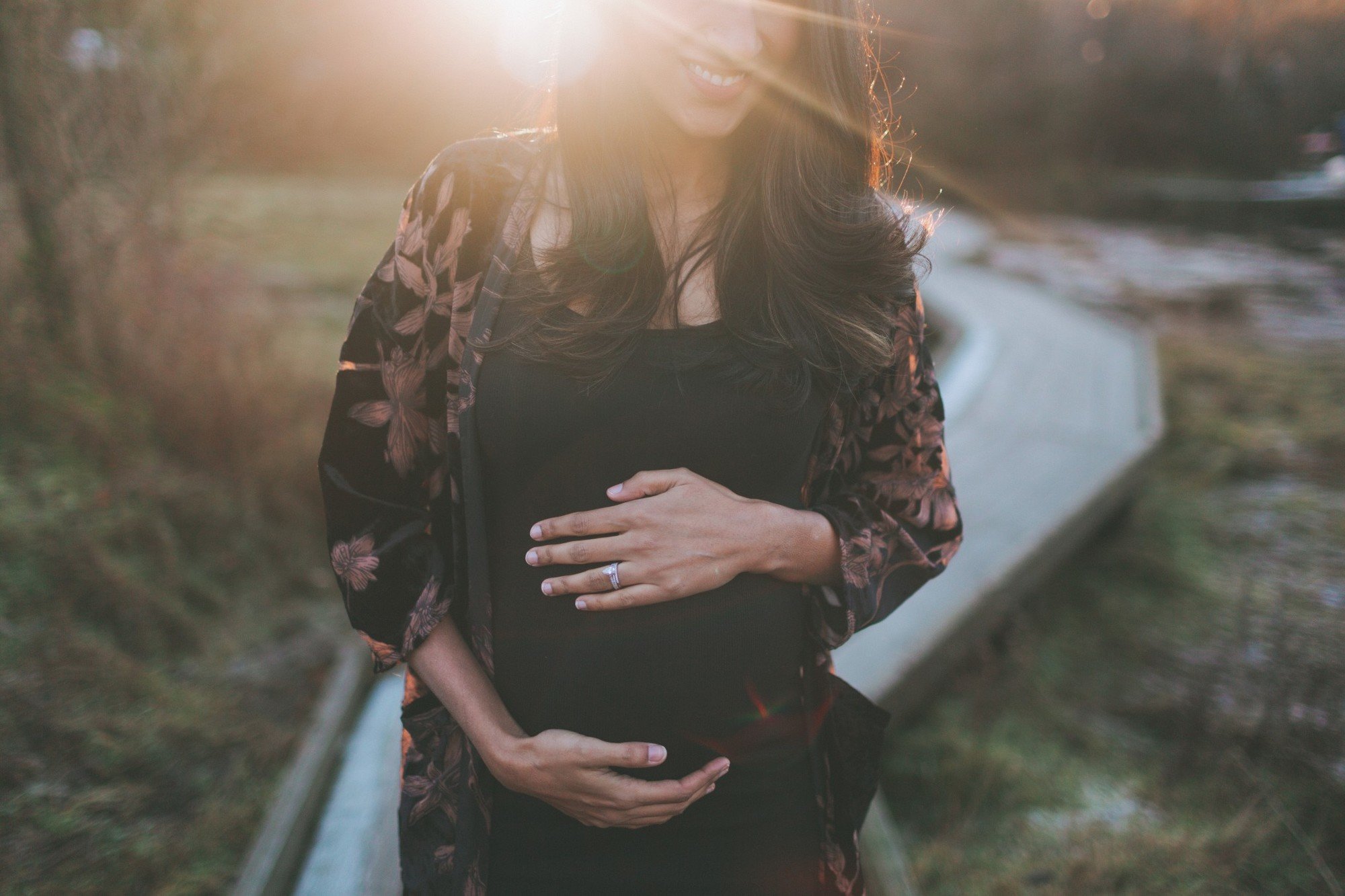 Pregnant woman outside in sunset