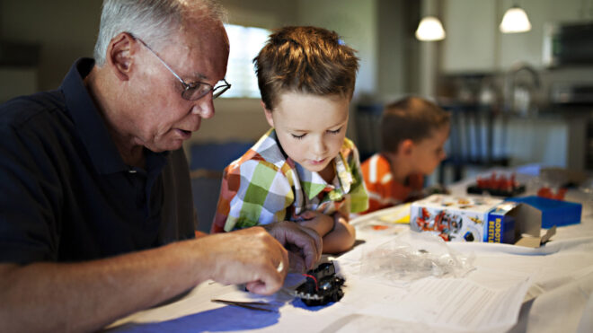 Grandpa works on craft with grandson