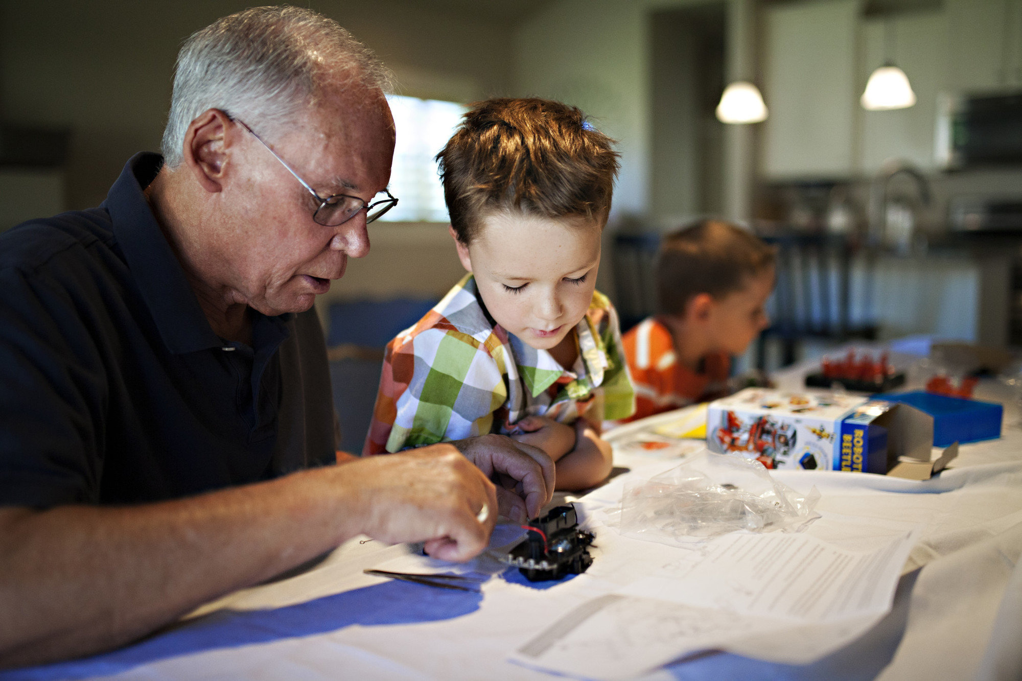 Grandpa works on craft with grandson