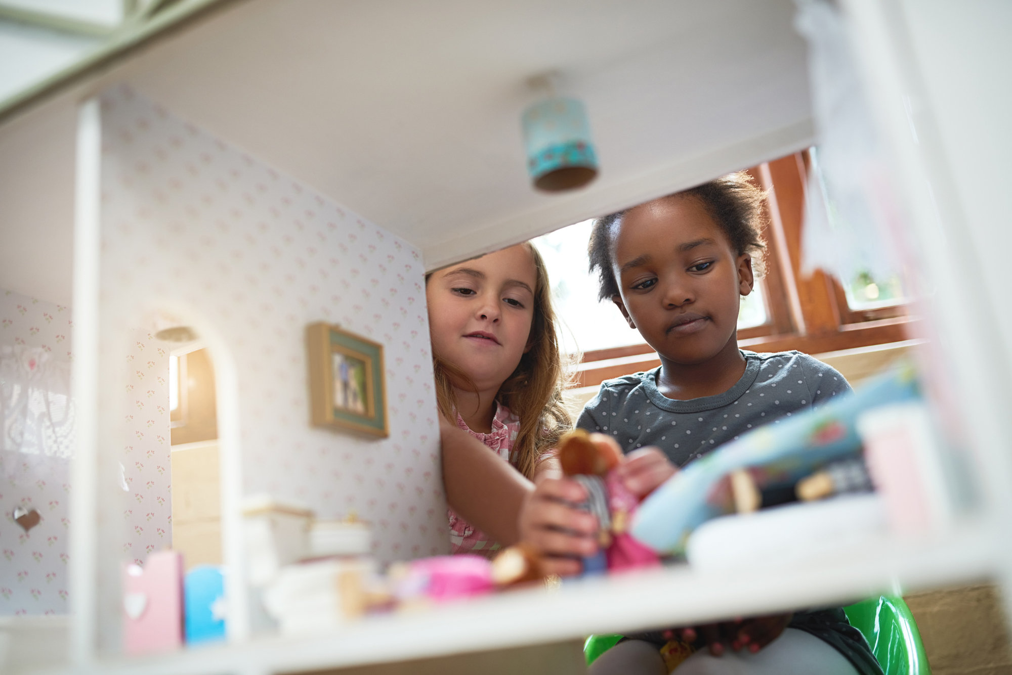 Two girls playing dollhouse