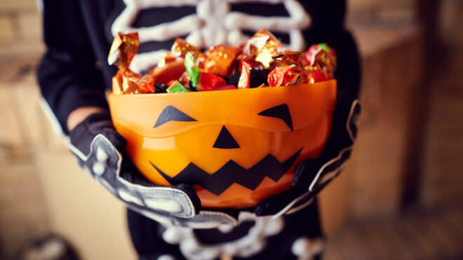 Boy holding candy bowl