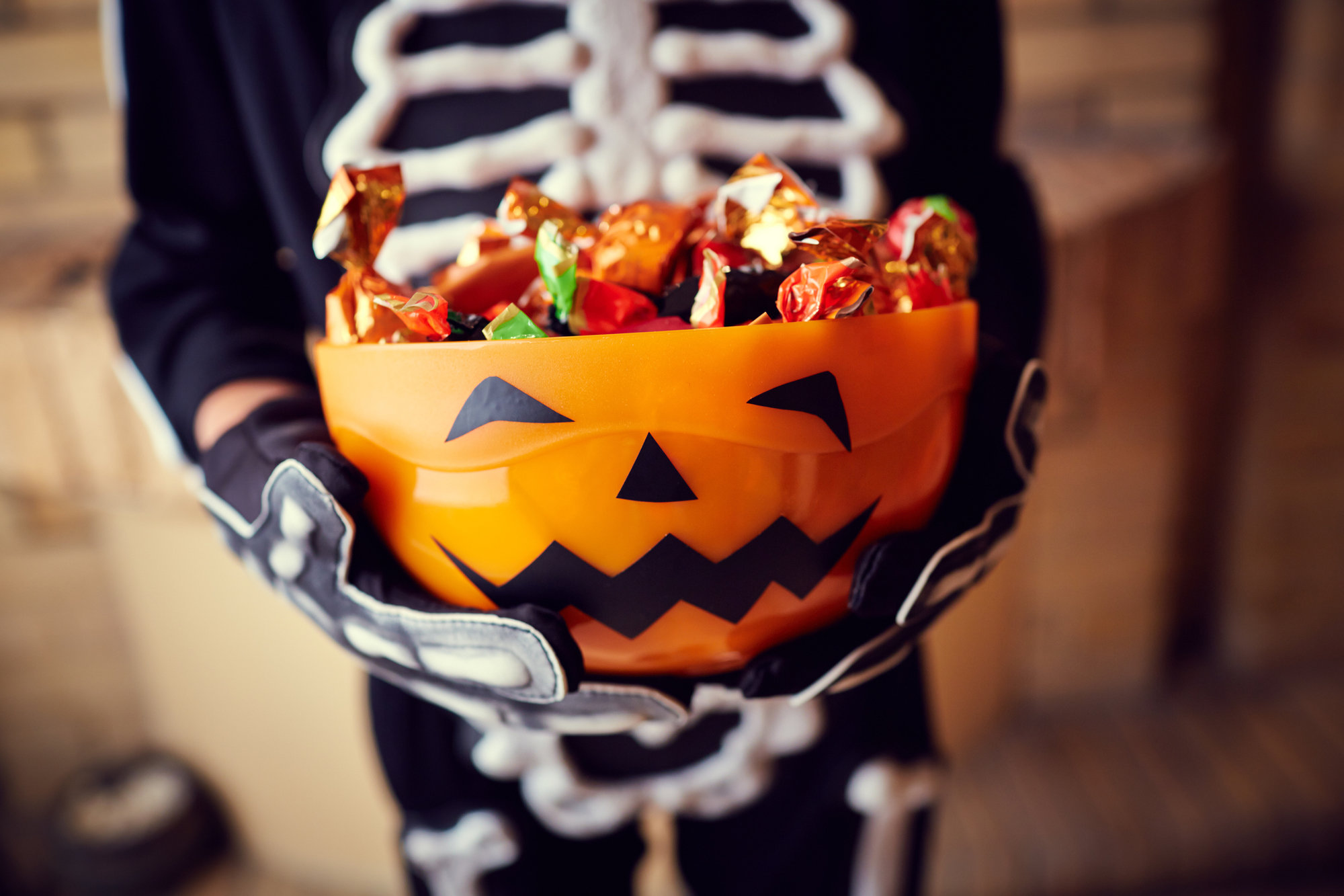 Boy holding candy bowl