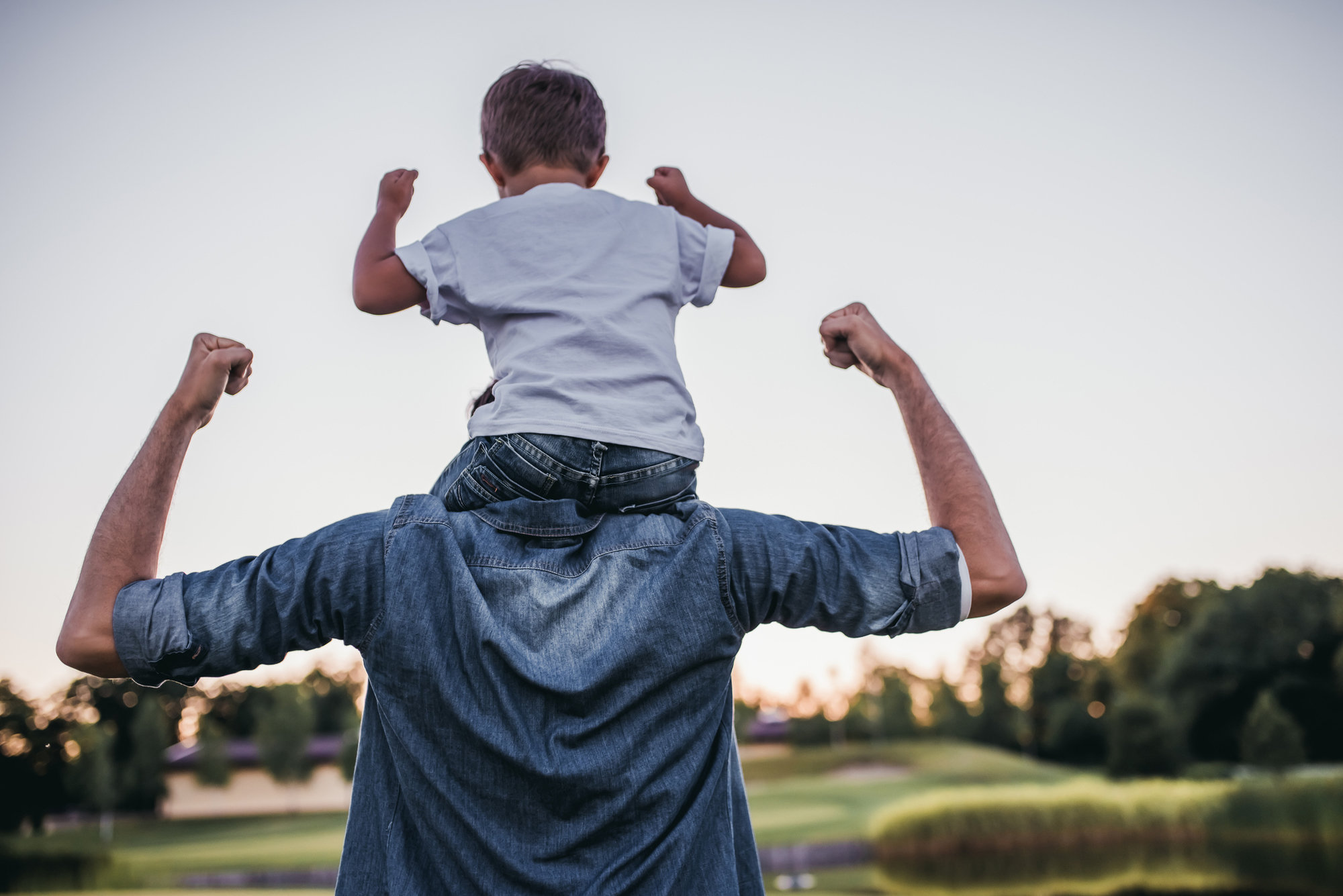 Boy sits on dad's shoulders