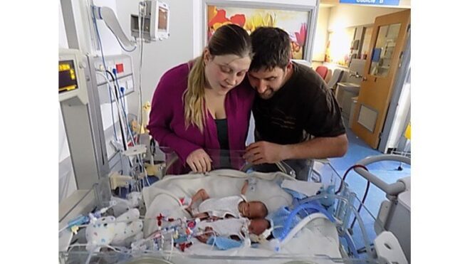 Max and Emily Bridges watch over their twins