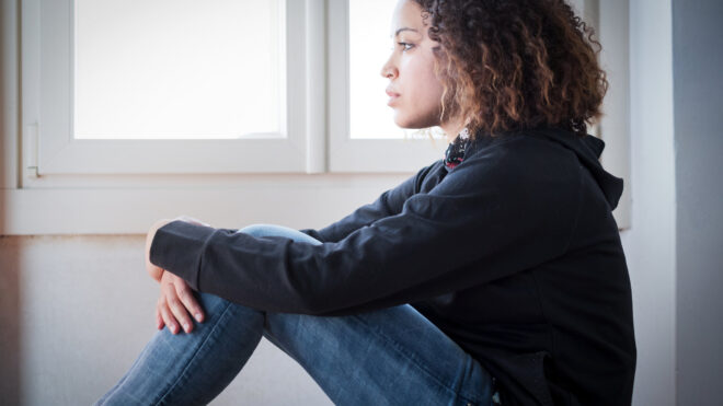 Alone and lonely young girl feeling depressed stock photo