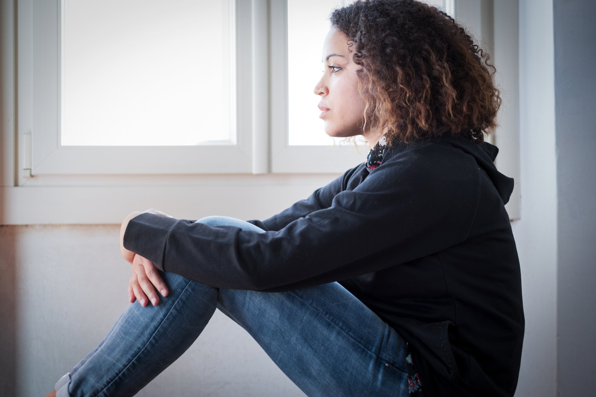 Alone and lonely young girl feeling depressed stock photo