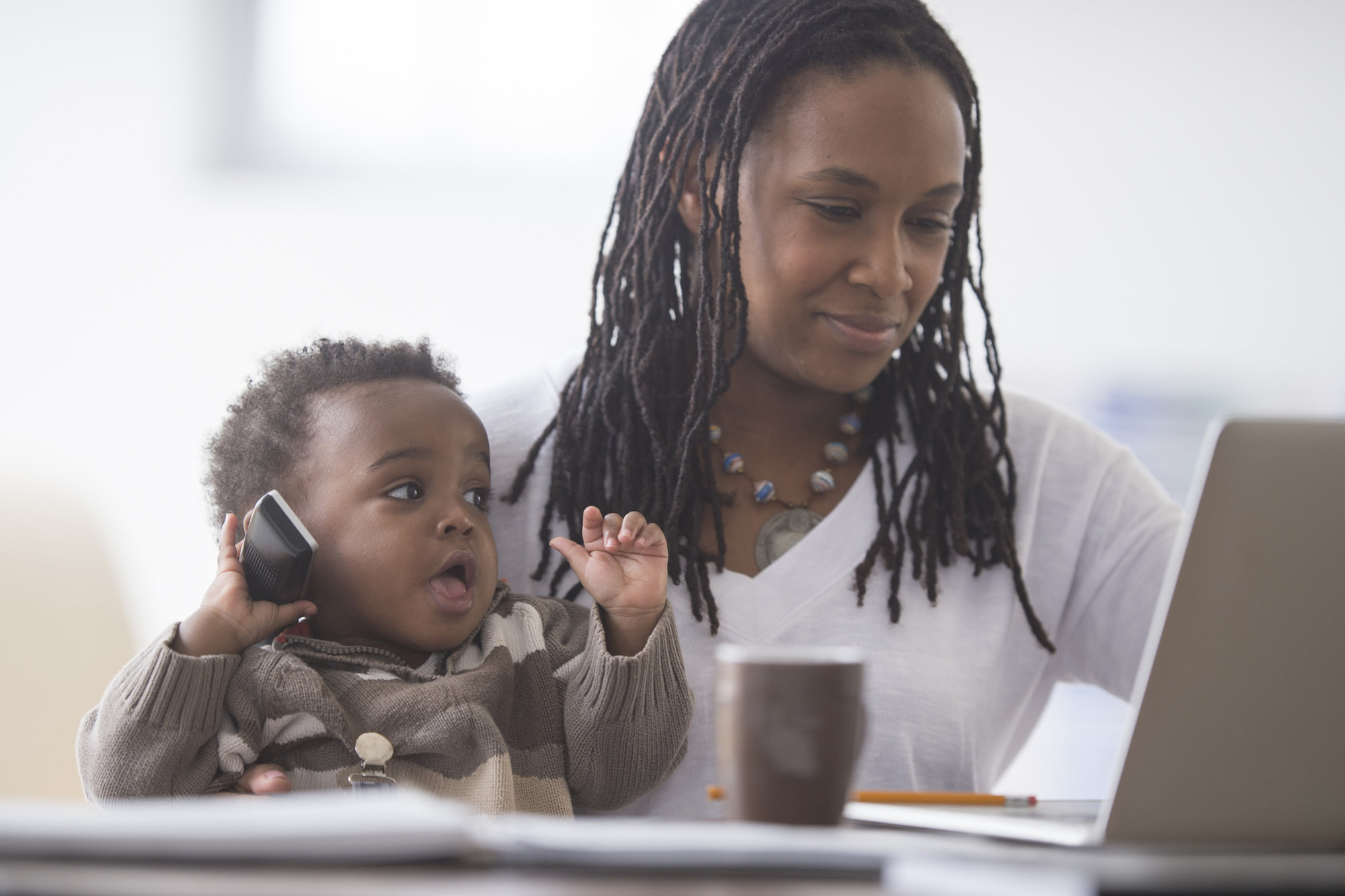 mom budgeting with baby at the table