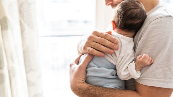 Dad holds newborn baby