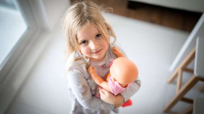 girl clutching doll