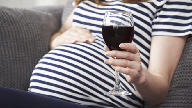 PRegnant woman drinking wine